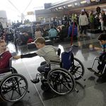 Some kids try out wheelchairs to pass the time at JFK